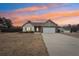 Ranch style home with stone accents, two-car garage, and landscaped yard at 7 Little Creek Manor Dr, Dallas, GA 30157