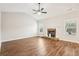 Spacious living room featuring hardwood floors, a stone fireplace, and a ceiling fan at 7 Little Creek Manor Dr, Dallas, GA 30157