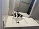 Bathroom with white vanity, black faucet, and framed mirror at 3973 Woodland Circle Se, Conyers, GA 30013