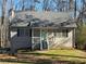 Charming ranch home with gray siding, light blue door, and a deck at 3973 Woodland Se Cir, Conyers, GA 30013