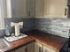 Kitchen corner with wood countertops and gray tile backsplash at 3973 Woodland Se Cir, Conyers, GA 30013