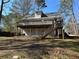 Multi-level home back exterior showing the deck and stairs to the ground level at 3973 Woodland Se Cir, Conyers, GA 30013