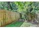 Small fenced backyard with grassy area and string lights at 574 Northridge Crossing Dr, Sandy Springs, GA 30350