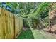 Small fenced backyard with grassy area at 574 Northridge Crossing Dr, Sandy Springs, GA 30350