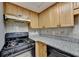 Black appliances and granite countertops in this kitchen at 574 Northridge Crossing Dr, Sandy Springs, GA 30350