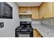 Kitchen features black stove and granite countertops at 574 Northridge Crossing Dr, Sandy Springs, GA 30350