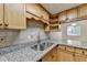 Kitchen boasts granite countertops and wood cabinets at 574 Northridge Crossing Dr, Sandy Springs, GA 30350