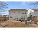 View of the back of the house featuring fenced yard, stone patio and mature landscaping at 702 Berkeley Ter, Canton, GA 30115