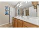 Bathroom featuring double vanity with white counter top, framed decor, and tile flooring at 702 Berkeley Ter, Canton, GA 30115