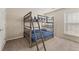 Bedroom featuring a bunk bed, carpet, and a window at 702 Berkeley Ter, Canton, GA 30115