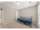 Bedroom with neutral walls, tan carpeting, and a metal bed frame and closet at 702 Berkeley Ter, Canton, GA 30115