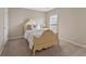 Charming bedroom featuring neutral walls, plush carpeting, and an elegant bed frame with a decorative headboard at 702 Berkeley Ter, Canton, GA 30115