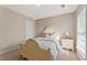 Bedroom with neutral walls, tan carpeting, bright window, and antique bed at 702 Berkeley Ter, Canton, GA 30115