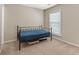 Bedroom with neutral walls, tan carpeting, and a metal bed frame at 702 Berkeley Ter, Canton, GA 30115