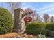 Stone community entrance sign nestled among lush greenery, giving a serene arrival experience at 702 Berkeley Ter, Canton, GA 30115