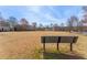 Overlook bench overlooking a large well kept community green space surrounded by a variety of neighborhood homes at 702 Berkeley Ter, Canton, GA 30115