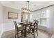 Dining area featuring modern chandelier, wood table, and neutral decor for intimate meals at 702 Berkeley Ter, Canton, GA 30115