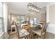 Well-lit dining area connected to the living room with a stylish light fixture at 702 Berkeley Ter, Canton, GA 30115