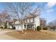 Charming two-story home featuring a manicured lawn, welcoming porch, and gray siding at 702 Berkeley Ter, Canton, GA 30115