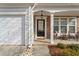 Inviting covered front porch with stone accents, seating area, and welcoming 