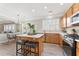 Kitchen with island, stainless appliances and eat-in table with chairs and chandelier at 702 Berkeley Ter, Canton, GA 30115