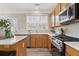 Kitchen view with stainless steel appliances, wood cabinets and stone countertops at 702 Berkeley Ter, Canton, GA 30115