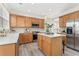 Well-lit kitchen featuring an island with barstool seating and stainless-steel appliances at 702 Berkeley Ter, Canton, GA 30115