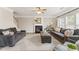 Spacious living room with couches, fireplace, and ceiling fan at 702 Berkeley Ter, Canton, GA 30115