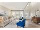 Sun-filled living room boasts tall ceilings, hardwood floors, and a neutral color palette at 702 Berkeley Ter, Canton, GA 30115