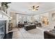 Open-concept living room with fireplace and view into kitchen at 702 Berkeley Ter, Canton, GA 30115