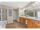 Main bathroom featuring tile floors, double vanity sinks, and glass shower at 702 Berkeley Ter, Canton, GA 30115