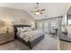 Serene bedroom featuring a tray ceiling, a ceiling fan, and elegant furnishings at 702 Berkeley Ter, Canton, GA 30115