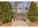 Stone pergola path leading to a lake view in between two beautiful trimmed bushes at 702 Berkeley Ter, Canton, GA 30115