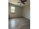 Well-lit bedroom with gray vinyl plank flooring at 622 Cloudland Dr, Stockbridge, GA 30281