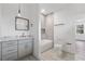 Modern bathroom with gray cabinets, a bathtub, and toilet at 1416 Elizabeth Sw Ave, Atlanta, GA 30310