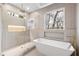 Spa-like bathroom with soaking tub, walk-in shower, and natural light at 1416 Elizabeth Sw Ave, Atlanta, GA 30310