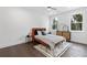Bright bedroom with wood floors, large windows, and a stylish bed at 1416 Elizabeth Sw Ave, Atlanta, GA 30310