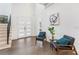 Elegant entryway with hardwood floors and two mid-century modern chairs at 1416 Elizabeth Sw Ave, Atlanta, GA 30310