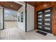 Modern front porch with wood ceiling and black double door at 1416 Elizabeth Sw Ave, Atlanta, GA 30310