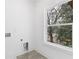 Bright laundry room with large window and tile flooring at 1416 Elizabeth Sw Ave, Atlanta, GA 30310