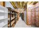This unfinished basement features wood and metal shelving for storage at 305 Corrigan Trce, Peachtree City, GA 30269