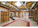 This unfinished basement includes an exercise area, shelving, and an exposed ceiling at 305 Corrigan Trce, Peachtree City, GA 30269