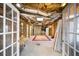 This unfinished basement has an exposed ceiling and shelving for storage at 305 Corrigan Trce, Peachtree City, GA 30269