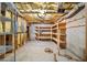 This unfinished basement features wood shelving and insulation at 305 Corrigan Trce, Peachtree City, GA 30269