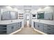 Dual sink bathroom with stylish vanities, open shelves, modern mirrors, and a connecting doorway at 305 Corrigan Trce, Peachtree City, GA 30269
