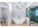 Elegant bathroom with a freestanding tub, glass shower, and high ceilings at 305 Corrigan Trce, Peachtree City, GA 30269