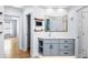 Bathroom vanity with modern mirror, open shelves, and a connecting doorway at 305 Corrigan Trce, Peachtree City, GA 30269