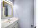 Stylish half bathroom featuring a gold mirror, vanity, and modern fixtures at 305 Corrigan Trce, Peachtree City, GA 30269