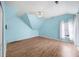Attic bedroom with a vaulted ceiling, bright blue walls, and hardwood floors at 305 Corrigan Trce, Peachtree City, GA 30269