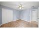 This bedroom features wood-look flooring, a ceiling fan, and a closet at 305 Corrigan Trce, Peachtree City, GA 30269